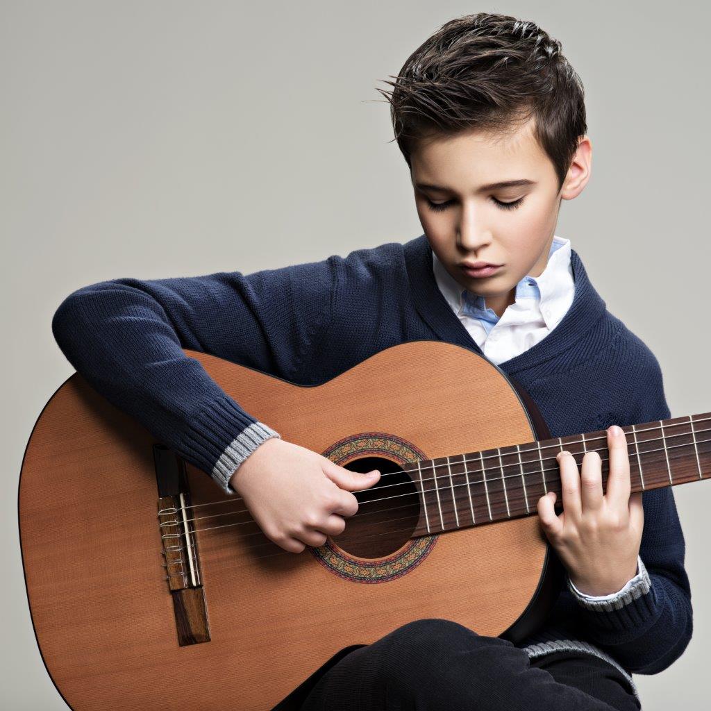 caucasian-boy-playing-acoustic-guitar